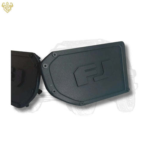 Pair of matte-black FJ Cruiser bumper corner caps with engraved “FJ” logo on white background.