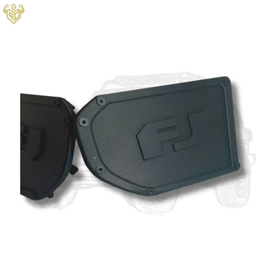 Pair of matte-black FJ Cruiser bumper corner caps with engraved “FJ” logo on white background.