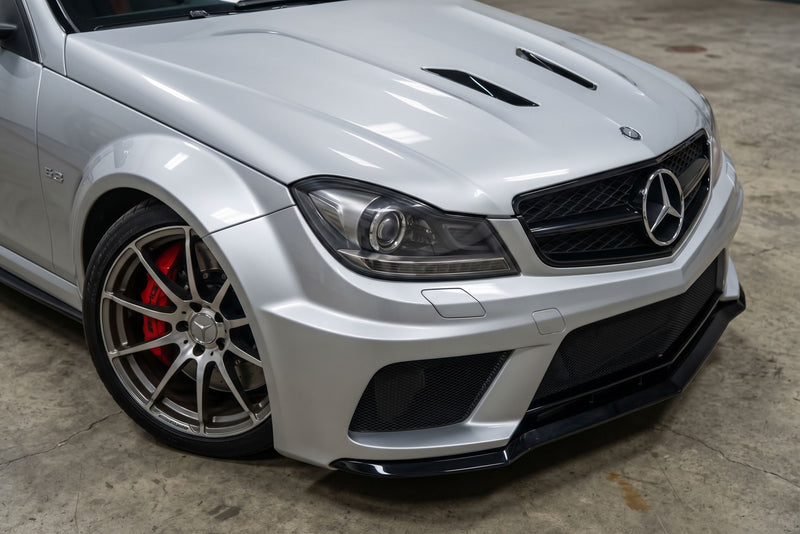 Silver Mercedes C63 AMG Black Series with the carbon fiber front lip, front corner view