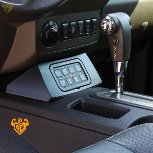 Nissan Xterra Auxbeam 8-gang switch panel in lower cubby — Rigid Custom Works